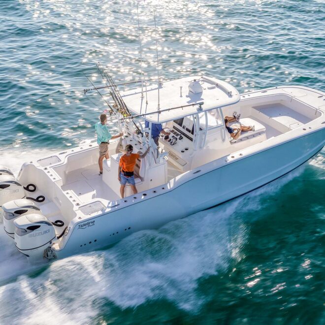 Powercat fishing boat running in blue water