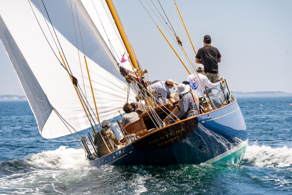 Sailboat heeling over with a racing crew. View from directly astern