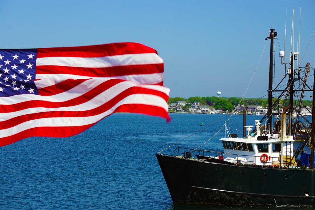 American Flag in the foreground, the bow of a commercial fishing boat to the right
