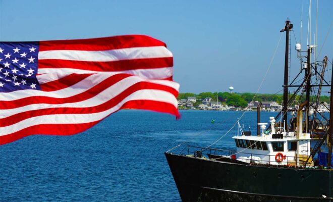 American Flag in the foreground, the bow of a commercial fishing boat to the right