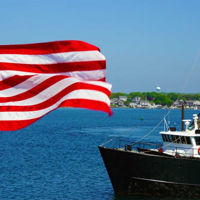 American Flag in the foreground, the bow of a commercial fishing boat to the right