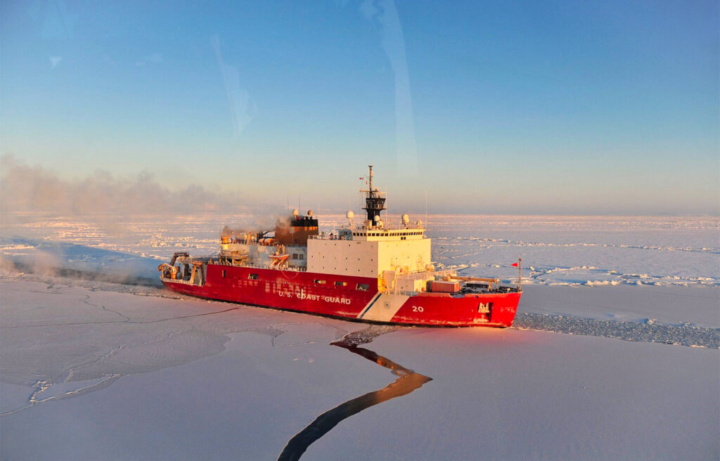 coast guard cutter moving through ice in the arctic