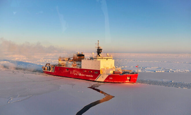 coast guard cutter moving through ice in the arctic