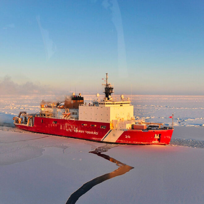 coast guard cutter moving through ice in the arctic