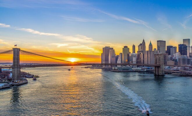 View of Brooklyn Bridge and Manhattan skyline at sunset