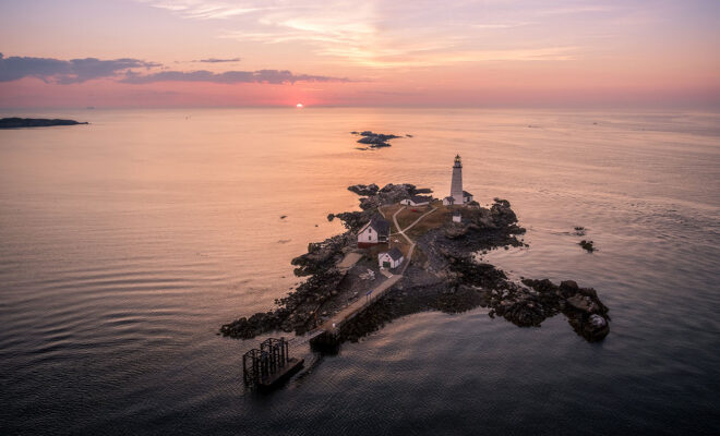 Aerial shot of Boston Islands lighthouse at sunrise.