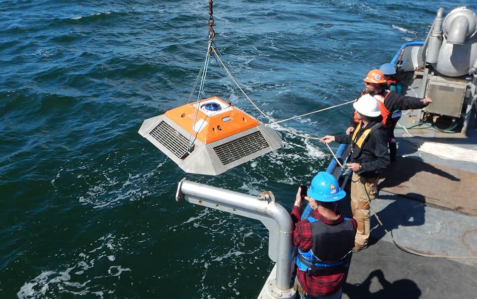 A NOAA team deploys a current meter to survey along the bottom of Puget Sound.