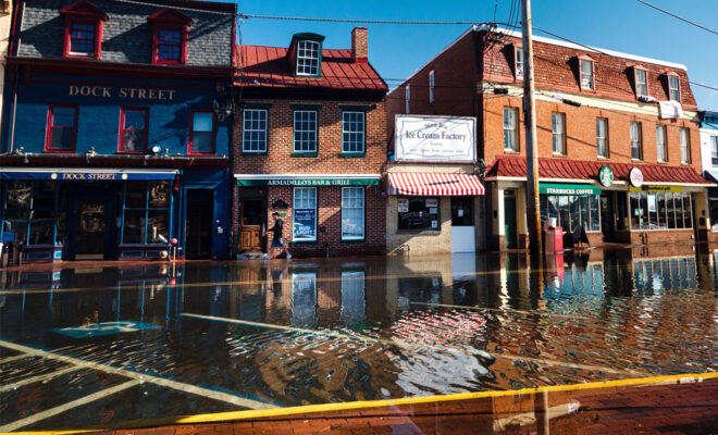 High-tide flooding on October 24, 2017, submerged roads and parking areas along Dock Street, in the historic heart of Annapolis, Maryland. Photo by Will Parson, Chesapeake Bay Program. Used with permission.