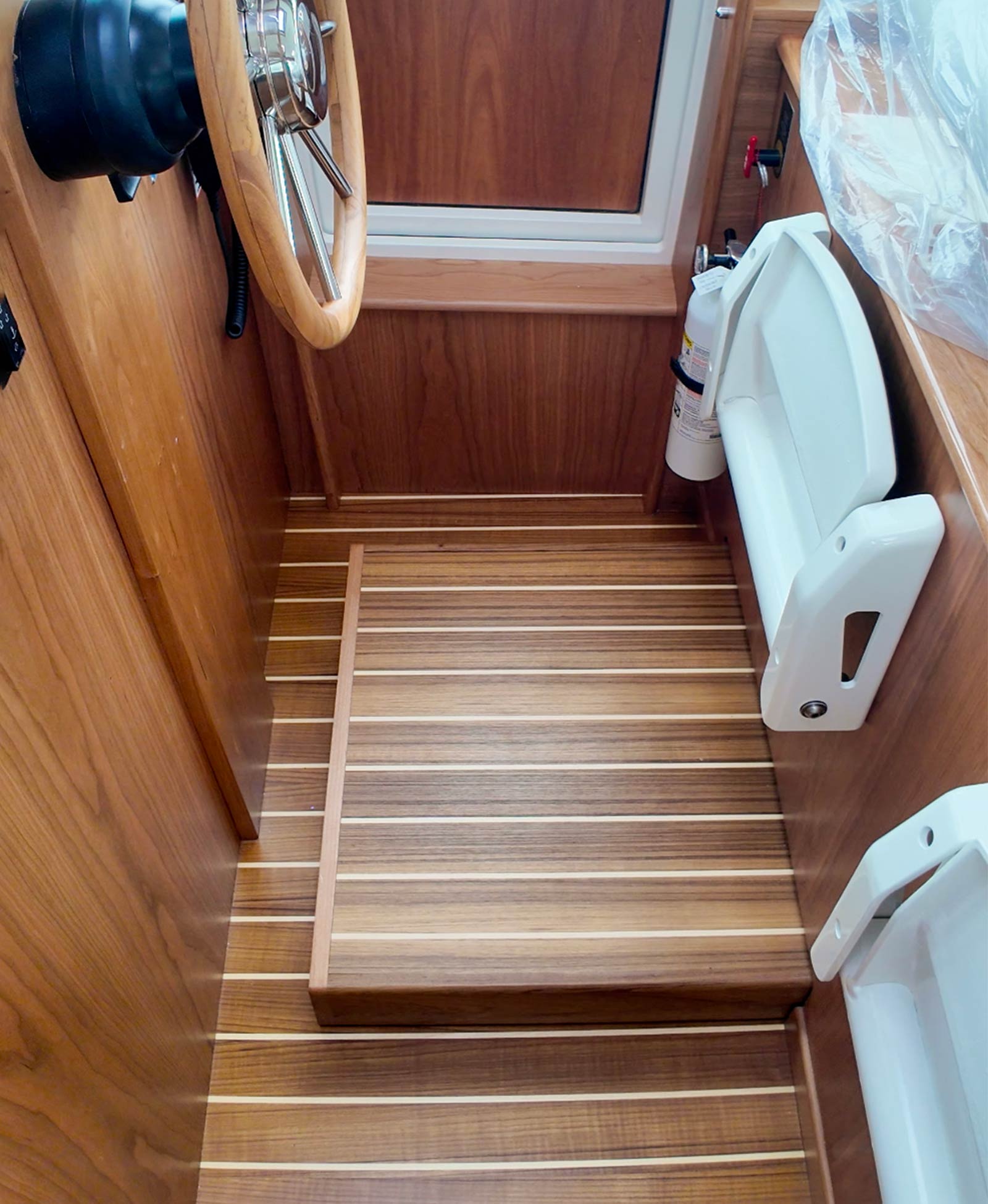 Powered step for added visibility while standing at the helm.