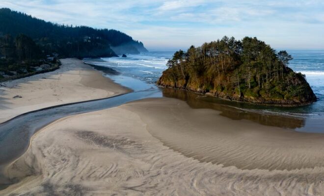 Neskowin Creek, a salmon stream in Tillamook County, Oregon, flows out to the Pacific Ocean. Credit: Adobe Stock