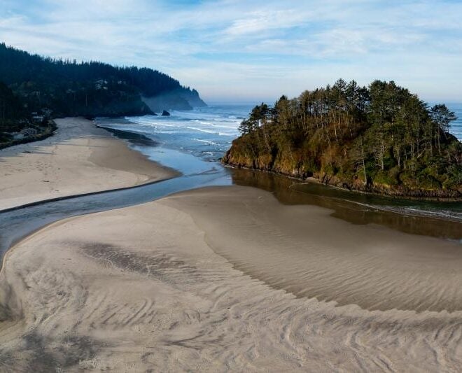 Neskowin Creek, a salmon stream in Tillamook County, Oregon, flows out to the Pacific Ocean. Credit: Adobe Stock