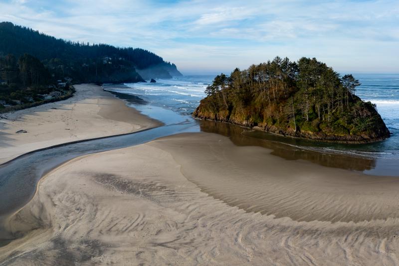 Neskowin Creek, a salmon stream in Tillamook County, Oregon, flows out to the Pacific Ocean. Credit: Adobe Stock