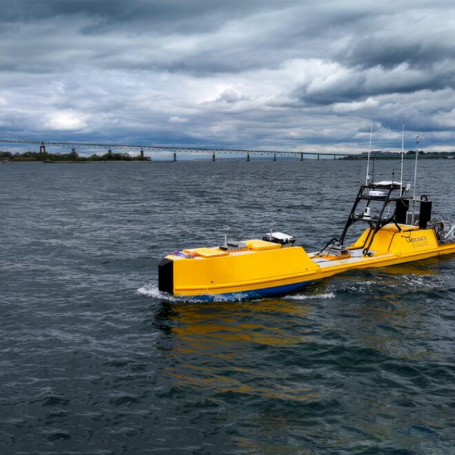 NOAA Autonomous Surface Vehicle in Narragansett Bay during testing. Goat Island and the Newport Bridge in the background.