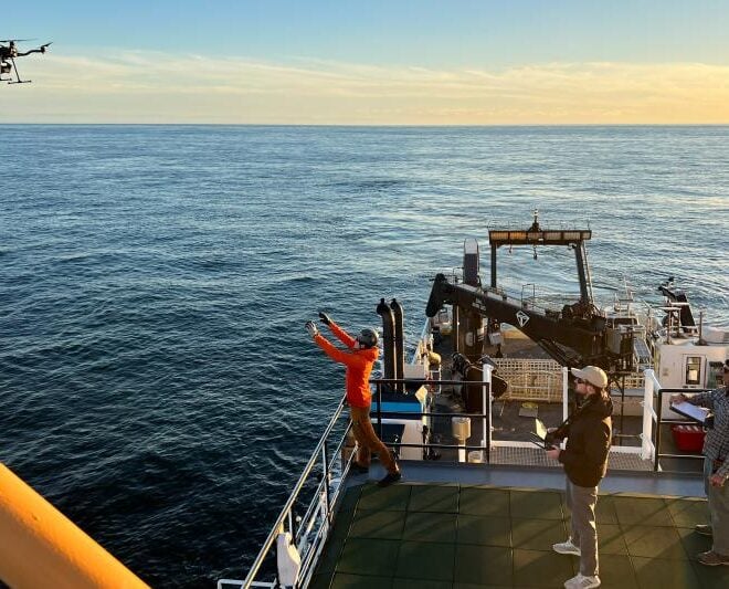 Rhyl Frith prepares to catch the FreeFly Astro research drone on the R/V Nancy Foster while tagging whales. Taken under NOAA permit # 27066. Credit: Julia Zeh
