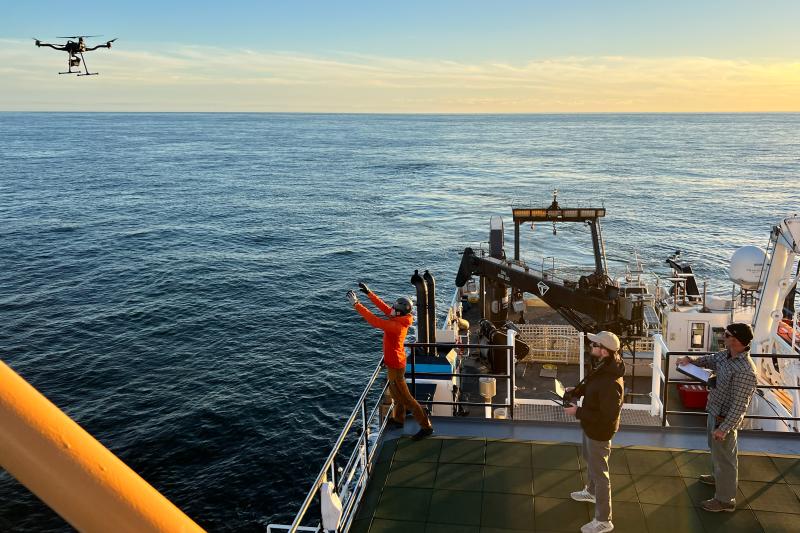 Rhyl Frith prepares to catch the FreeFly Astro research drone on the R/V Nancy Foster while tagging whales. Taken under NOAA permit # 27066. Credit: Julia Zeh