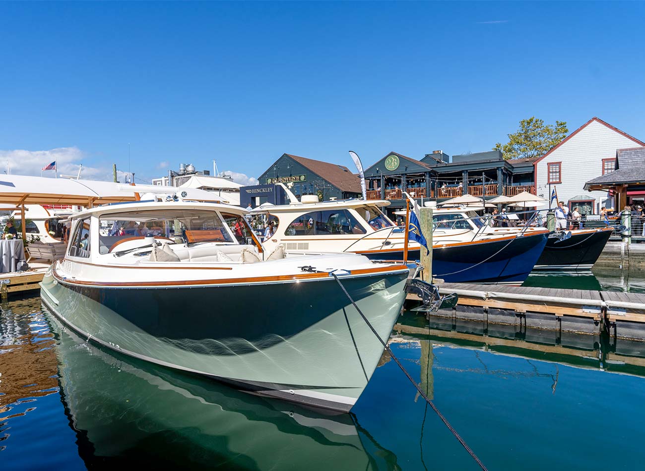 three boats docked in calm water